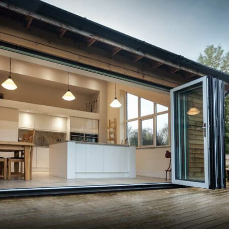 SW Plastic Windows. Beautiful Bi-folding doors open wide into a open plan kitchen.