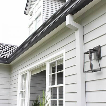 SW Plastic Roof Lines. Dark cladding on a white panelled house.