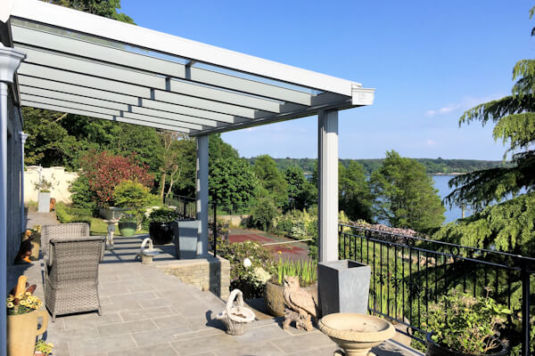 SW Plastic Canopies. Traditional Veranda overlooking the garden, into a lake.